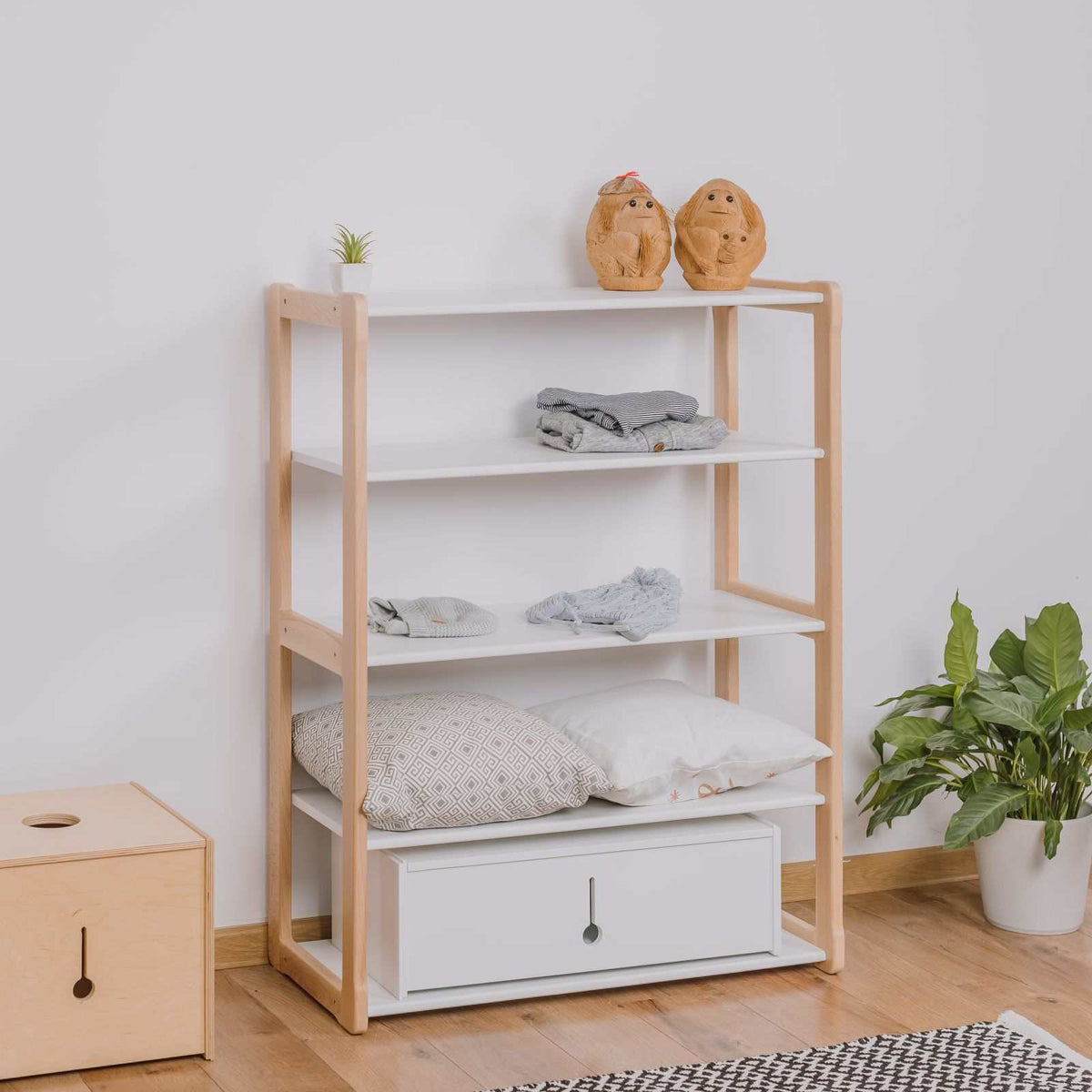 Montessori-inspired wooden wardrobe with shelves and two maxi shelves, promoting child independence and self-confidence.