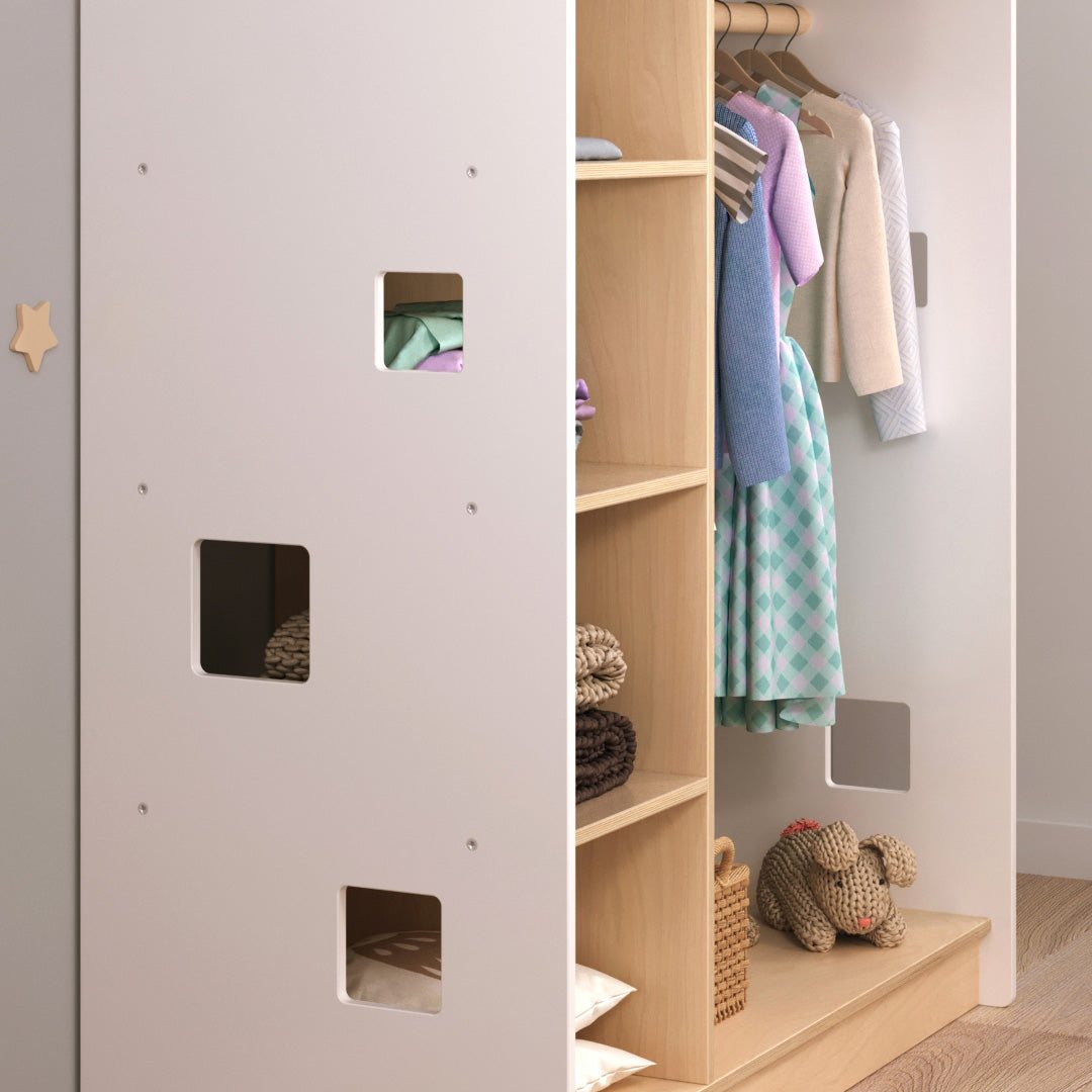White house-shaped open children&#39;s wardrobe, Montessori-inspired design, with shelves and hangers for clothing organization.