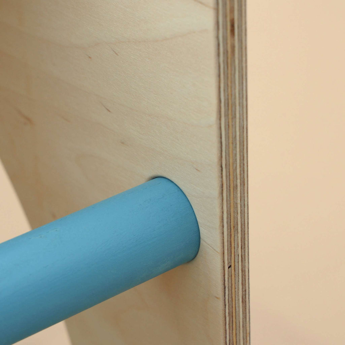 Close-up of Montessori® climbing cube made from Baltic birch wood with mint-colored details.