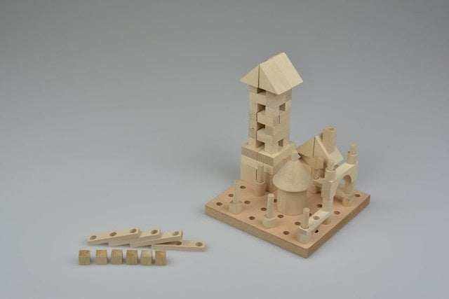 Wooden building set for children, includes 120 drilled parts and assembly board.