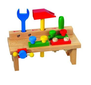 Wooden toy workbench with colorful tools, including screwdriver, hammer, and wrench, for children's motor skills development.