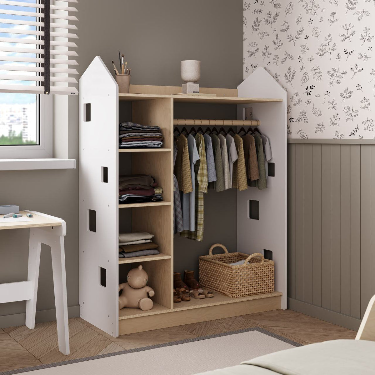 White open children&#39;s wardrobe shaped like a house with shelves and hanging space, Montessori-inspired design, in a modern kid&#39;s room.