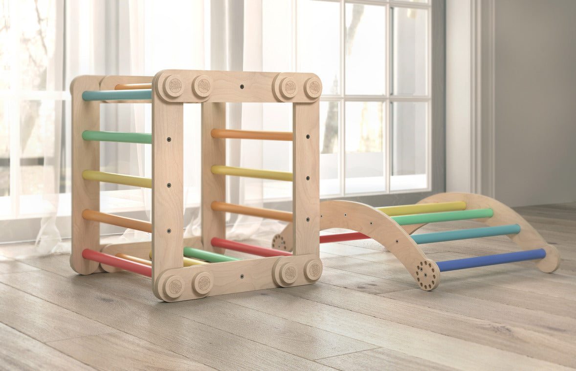 Children&#39;s rainbow-colored climbing set with swing, featuring two Pikler triangles and sturdy birch wood construction.