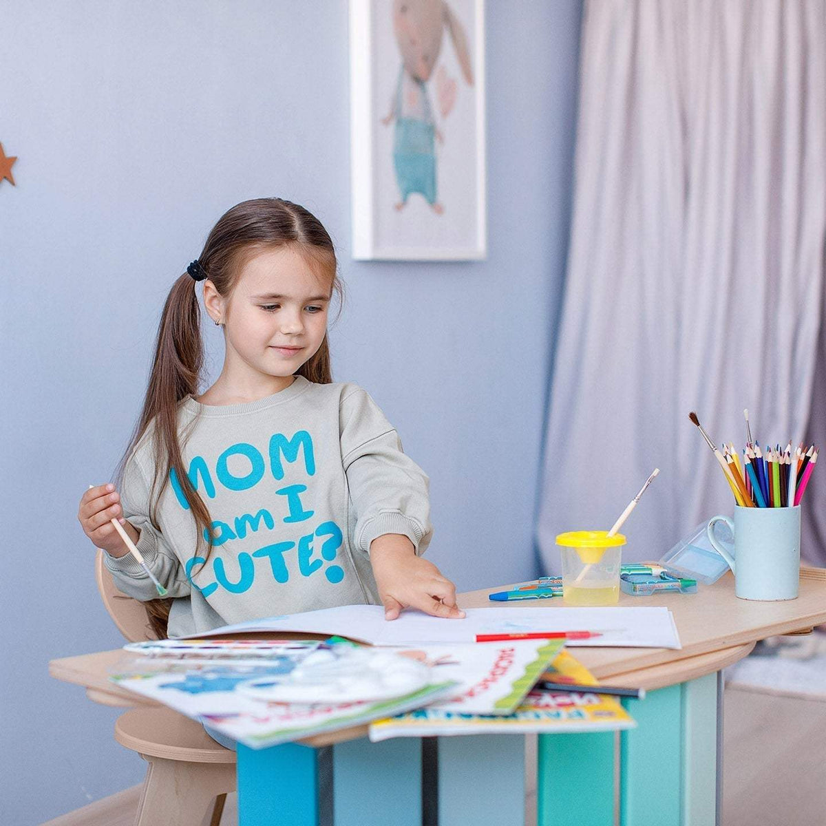 Child using mint-colored set with rocker, double-sided board, and mini chair.