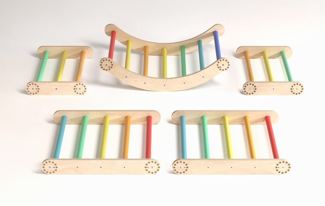 Children&#39;s rainbow-colored climbing frame set with swing, featuring Pikler triangles and sturdy birch wood construction.