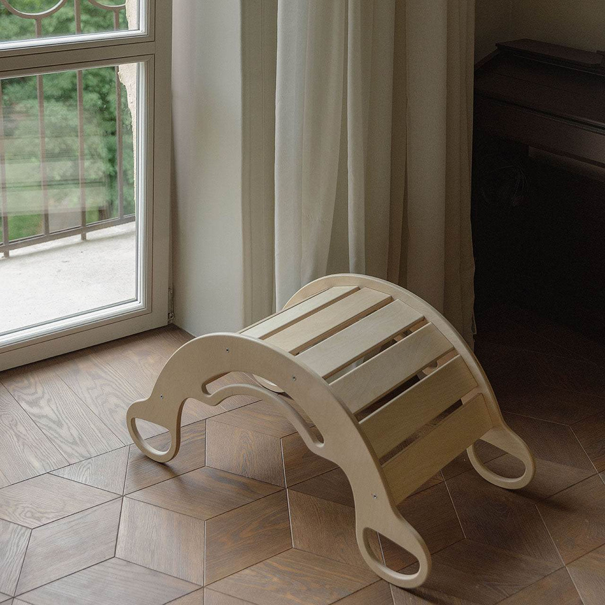 Wooden rocker for kids&#39; play and exercise, versatile design suitable for small spaces.
