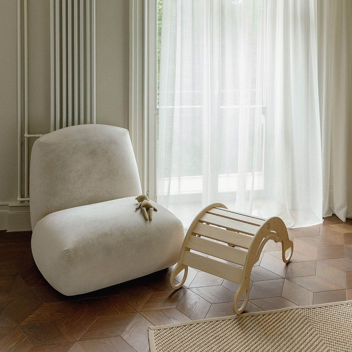 Multipurpose wooden rocking chair for kids, suitable from 1 year, in a modern living room.