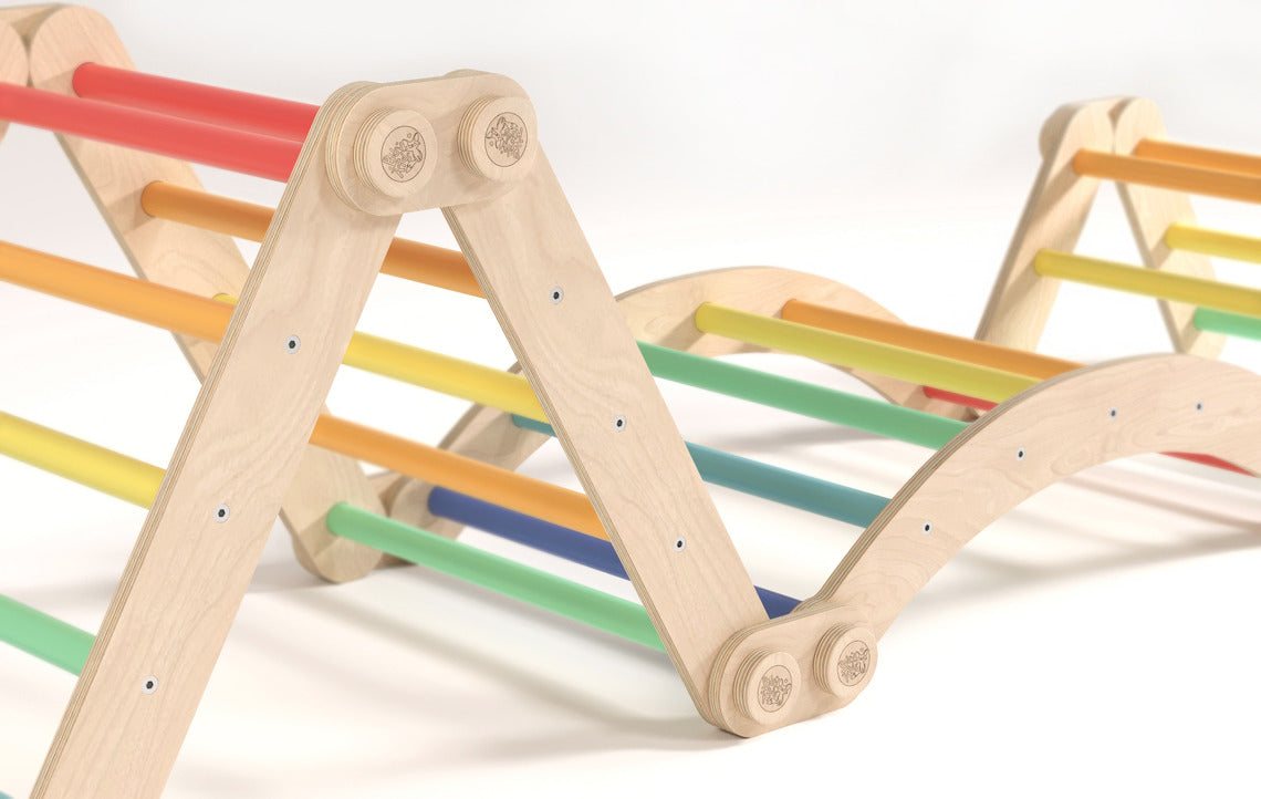 Rainbow-colored children&#39;s climbing frame set with swing, featuring sturdy birch wood construction and versatile assembly options, suitable for indoor play.