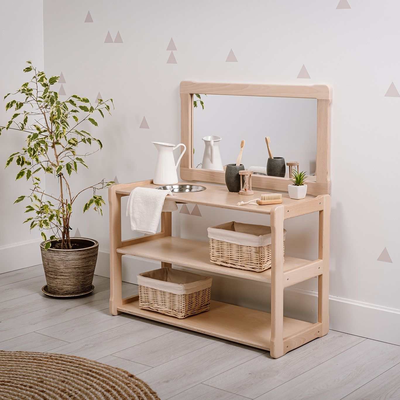 Montessori® wooden sink and mirror set for children with shelves and storage baskets.