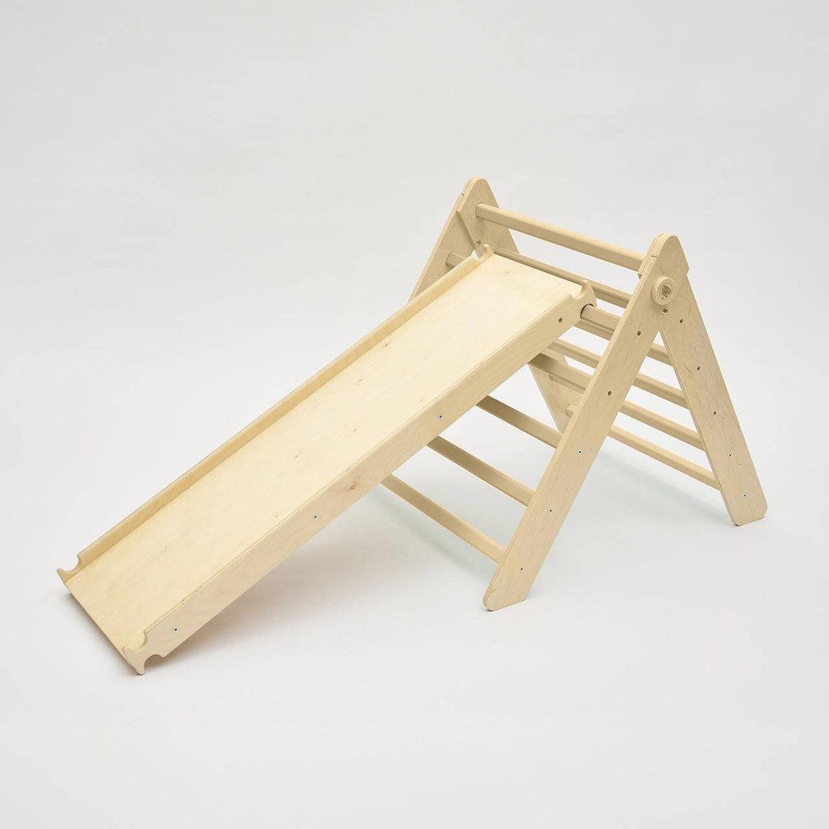 Natural wooden climbing triangle with slide for children&#39;s play and motor skill development.