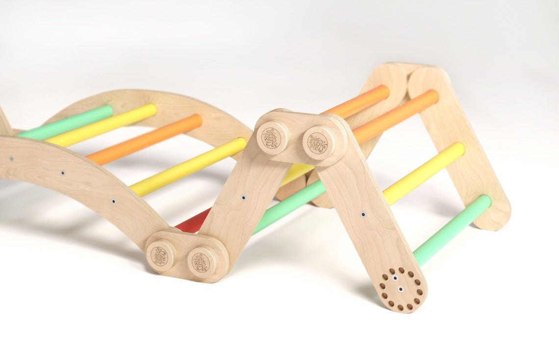 Colorful wooden climbing set for children featuring climbing triangles and a swing.