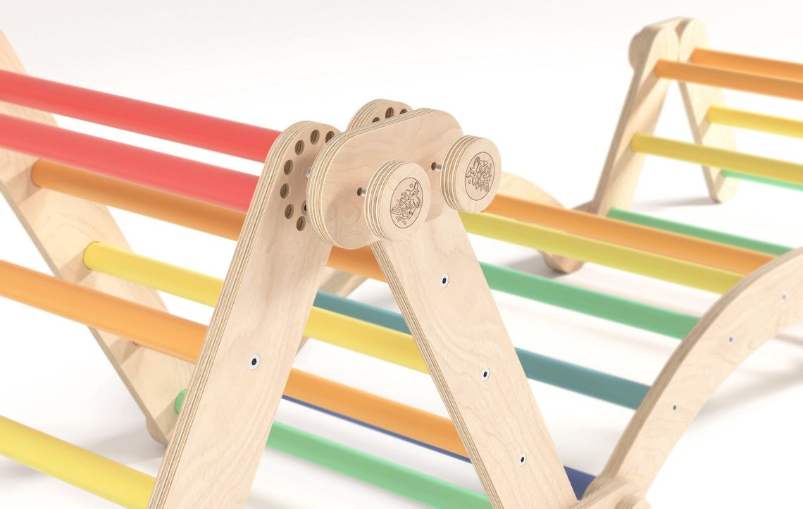 Rainbow-colored children&#39;s climbing frame set with swing, made of birch wood.