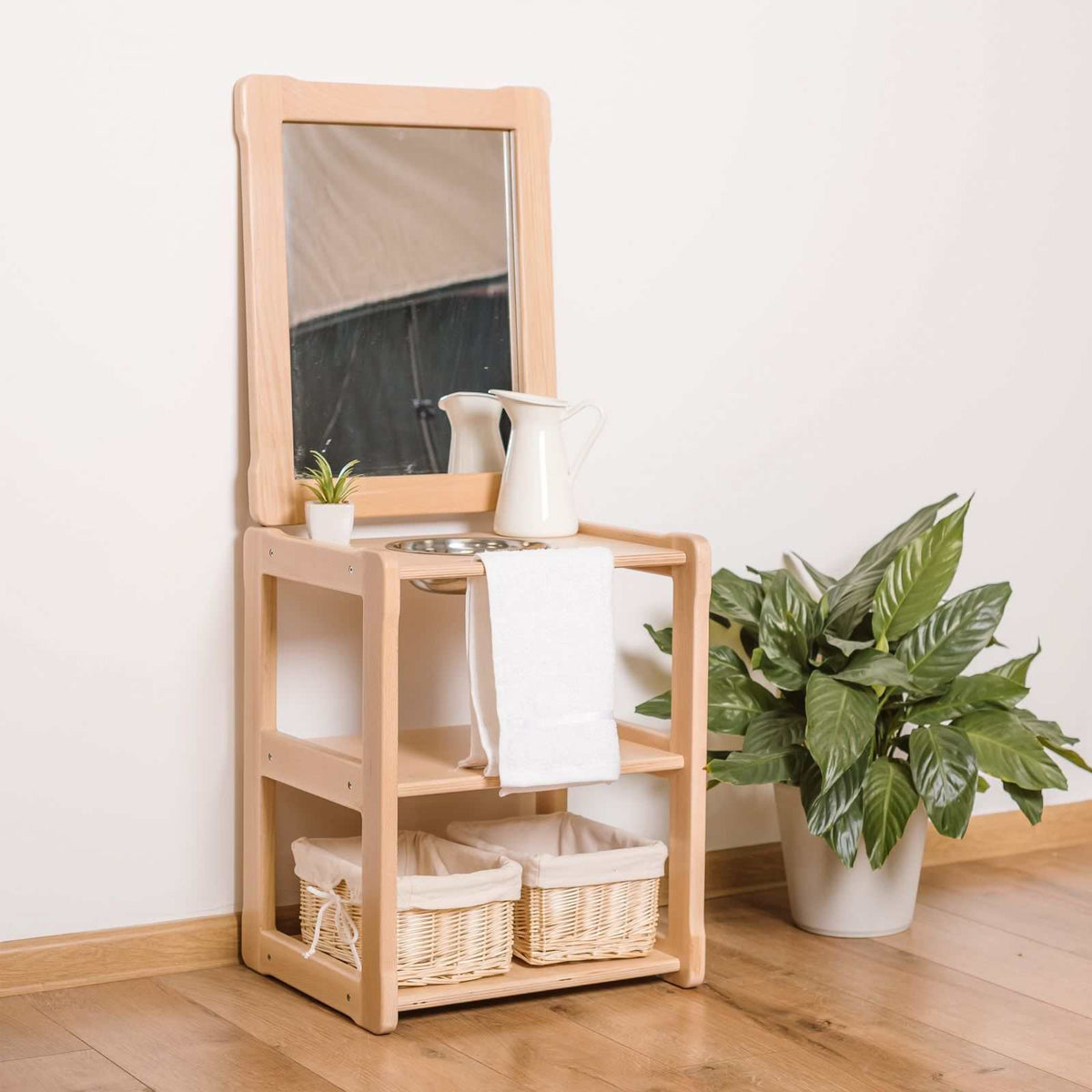 Children&#39;s sink with mirror, wooden frame, and shelves, designed for easy access; perfect for hand washing and grooming without a stool.