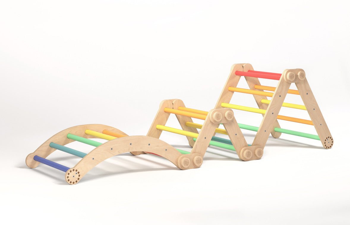 Rainbow-colored children&#39;s climbing set with swing, featuring Pikler triangles.