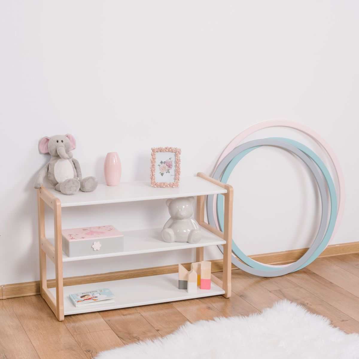 Montessori-inspired Regal Mini bookshelf with toys and books, in a children&#39;s room setting.