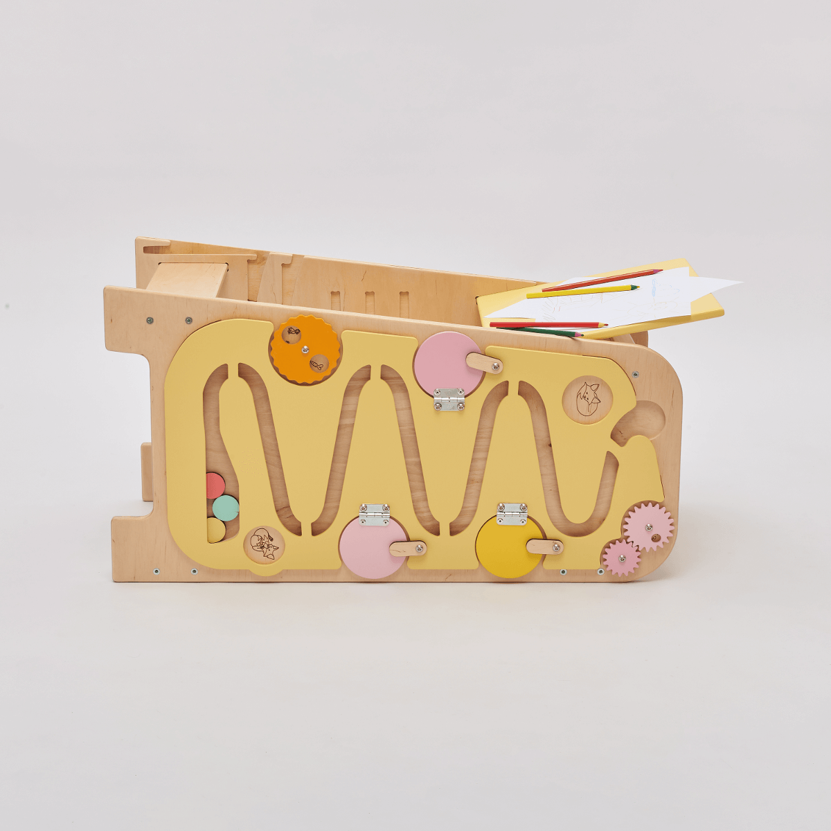 Multifunctional yellow learning tower with play elements and adjustable height.