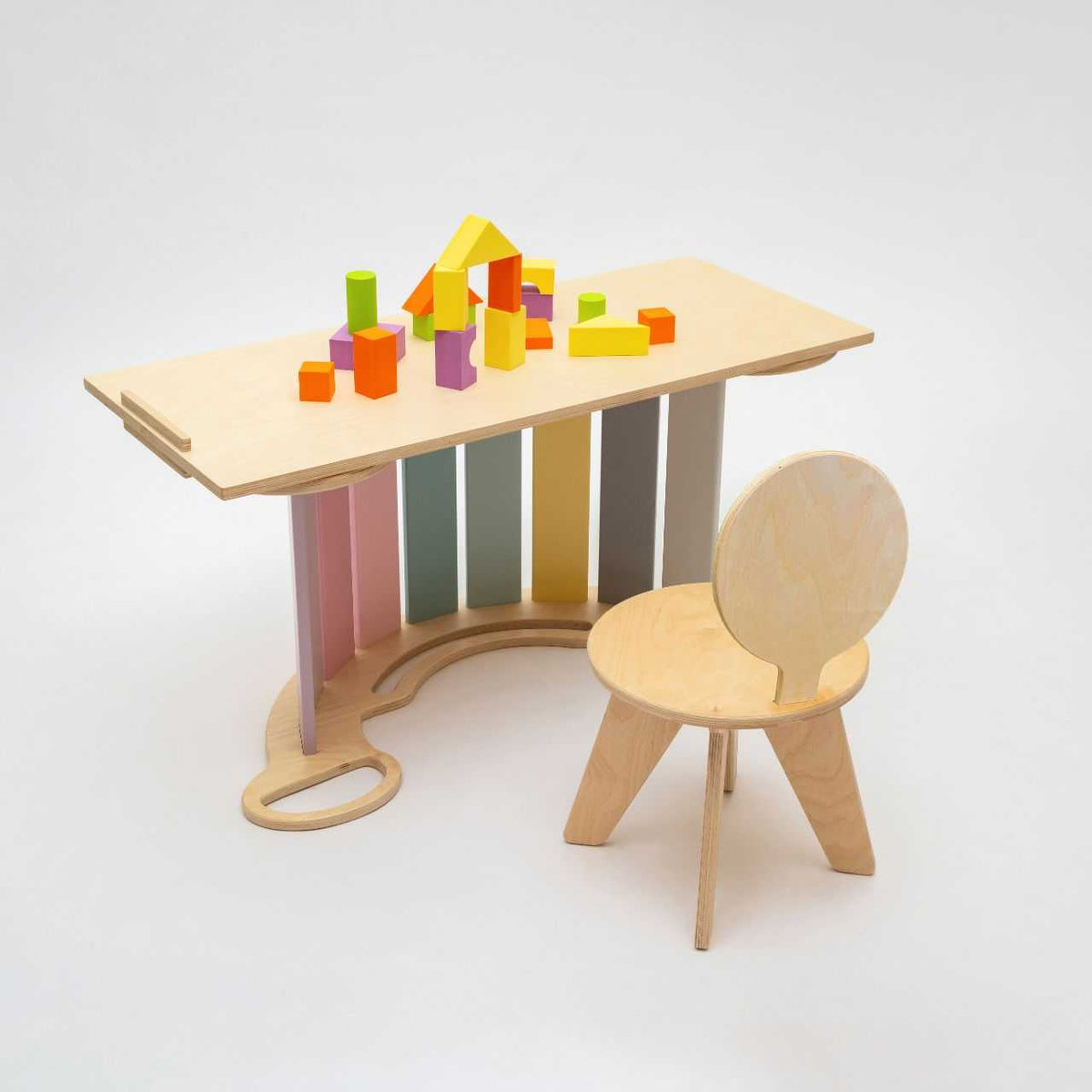 Set of pastel-colored seesaw, double-sided board, and mini chair for children.