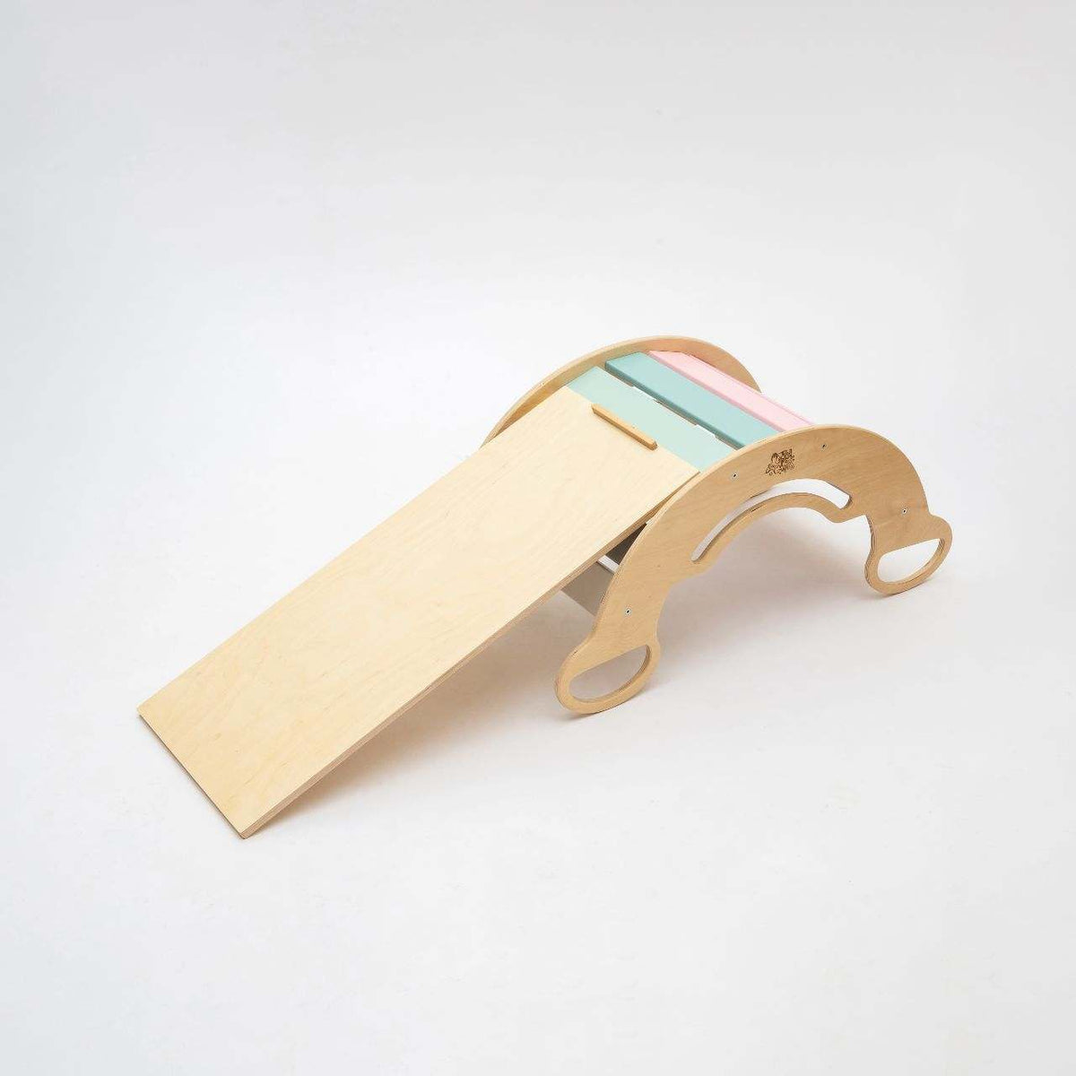 Montessori 5-in-1 wooden rocker with pastel double-sided board for children&#39;s motor skills development.