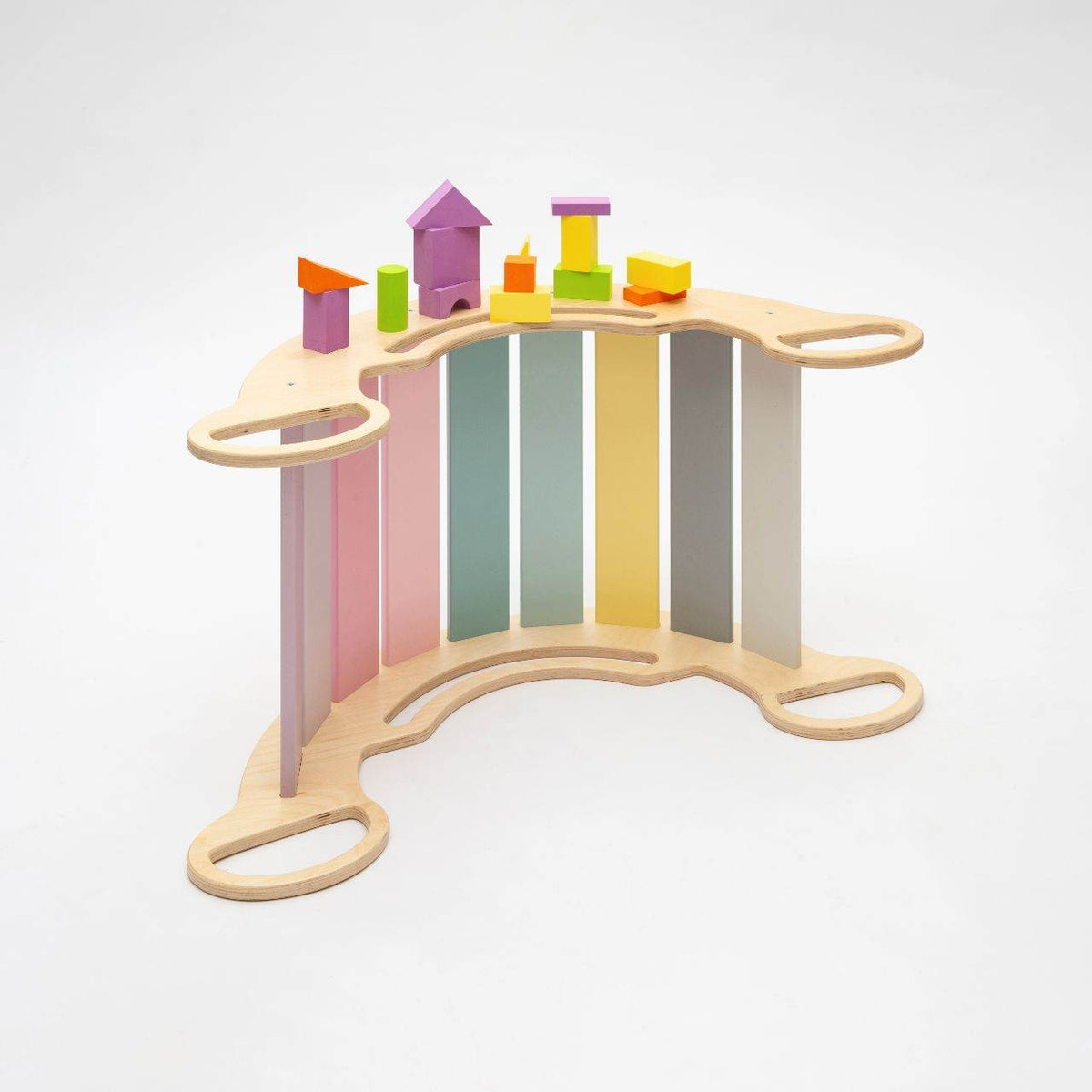 Montessori 5-in-1 pastel wooden balance rocker with reversible board and colorful climbing wall for motor skill development.
