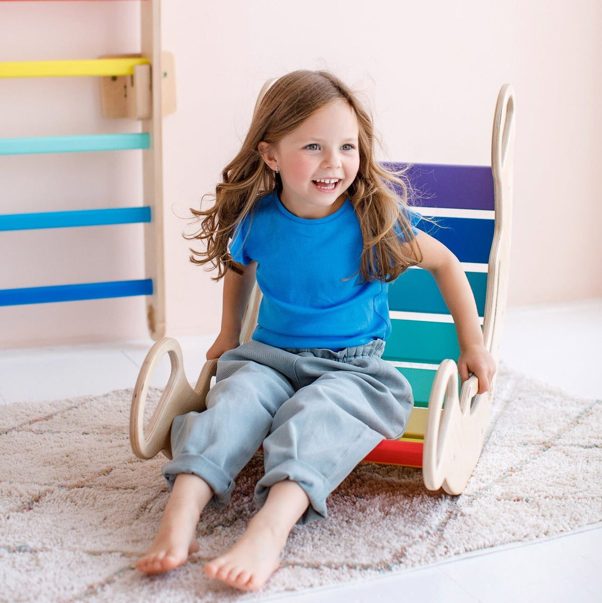 Wooden balance rocker for kids featuring vibrant colors, promoting creativity and physical activity for children aged 1 and up.