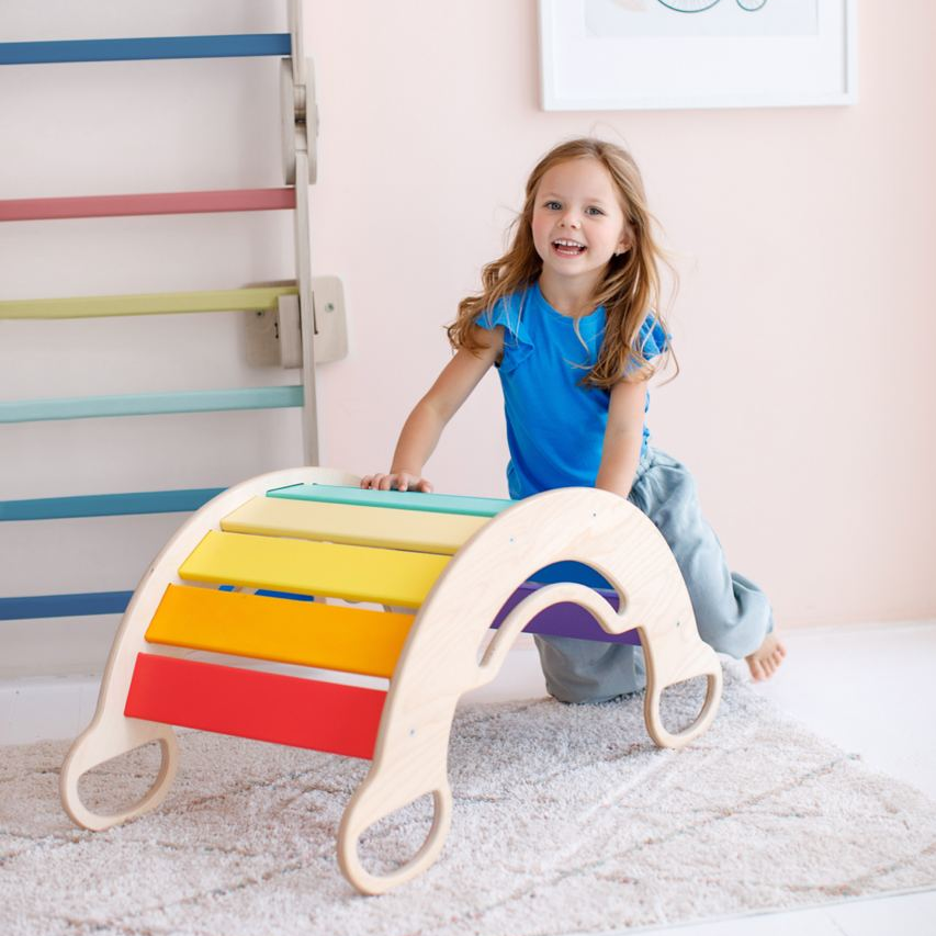 Multifunctional wooden rocker in light colors for kids, promotes movement and creativity.