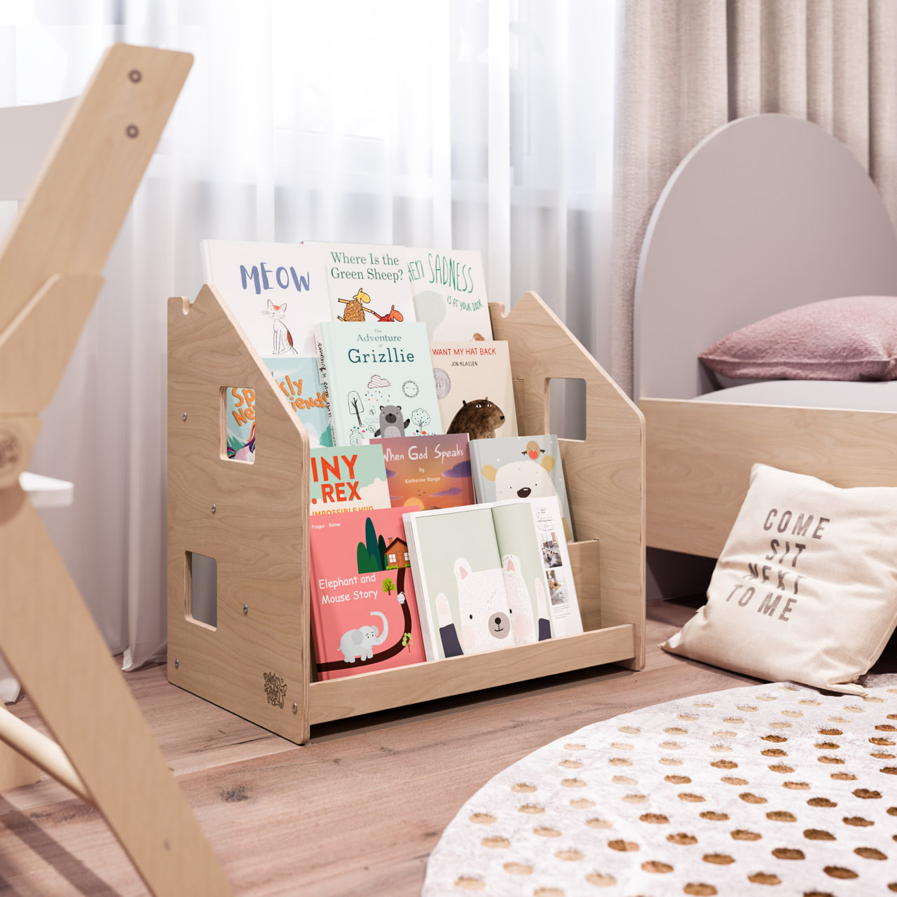 Montessori-inspired children's bookshelf with visible book covers and four compartments, designed for accessibility and independence.
