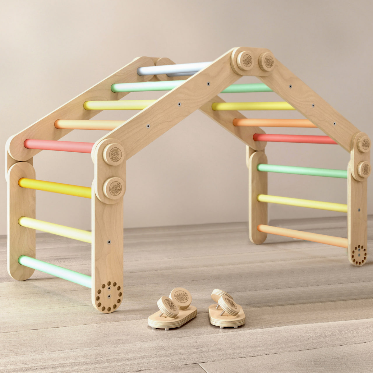 Children&#39;s wooden climbing set with adjustable Pikler triangles in pastel colors on a wooden floor.