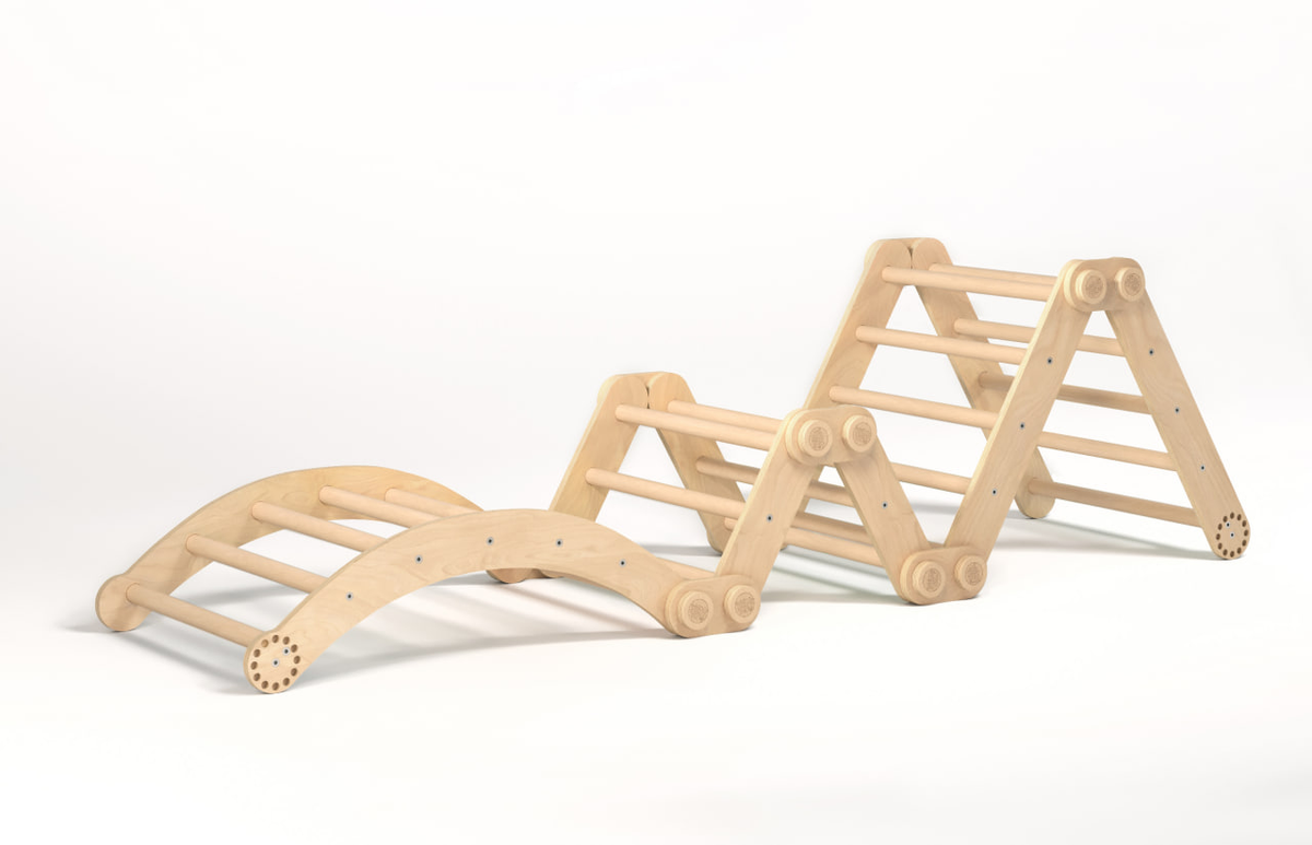 Natural wooden children&#39;s climbing set with swing featuring two Pikler triangles and a low swing.