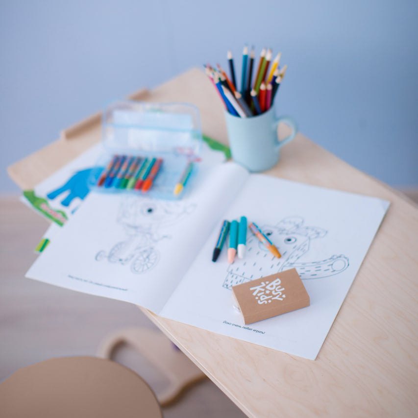 Children&#39;s furniture set including a light-colored seesaw, double-sided board, and mini chair.