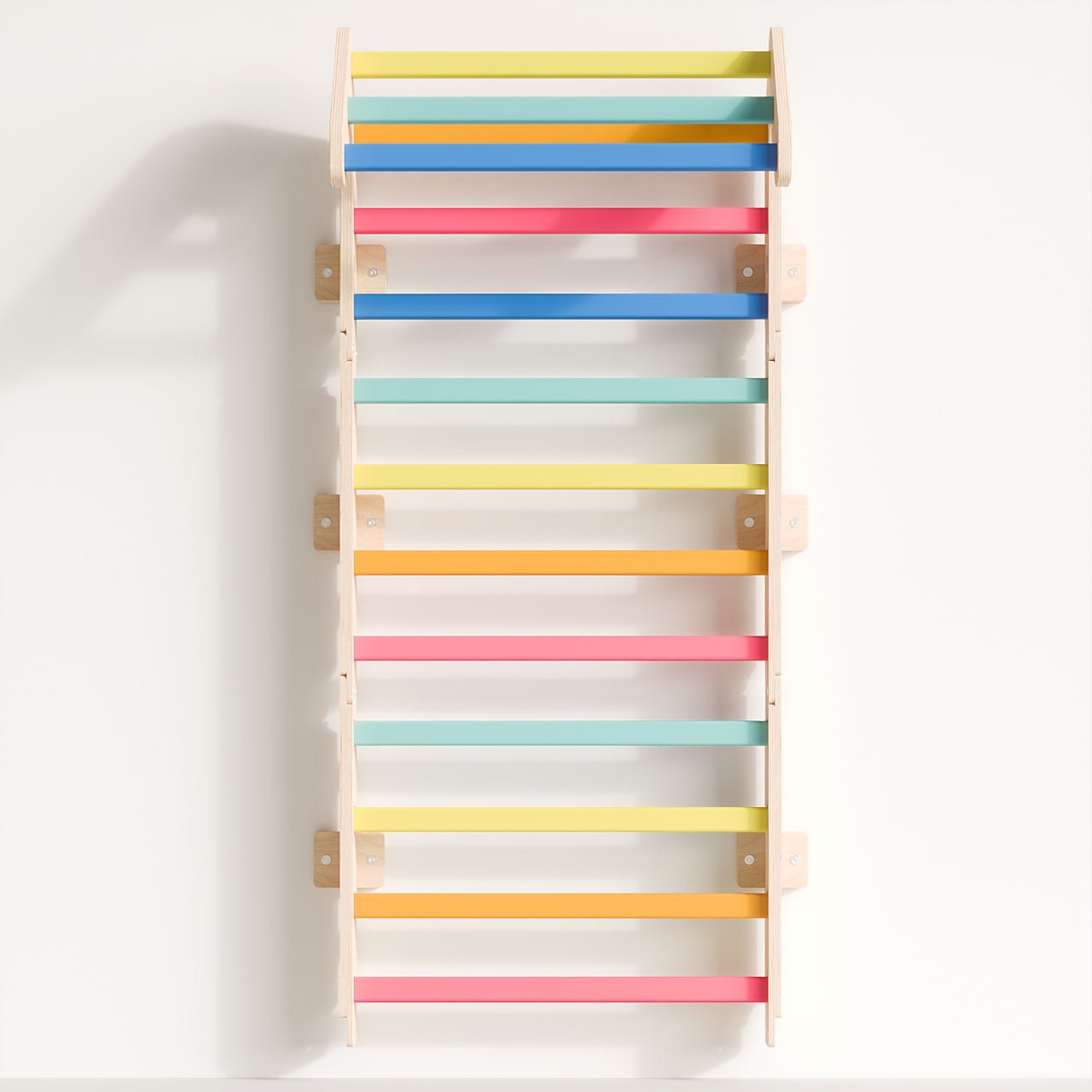 Indoor wooden climbing wall for kids, Sprossenwand Mini by BusyKids, made from birch plywood and beechwood, featuring colorful steps for motor skills development.
