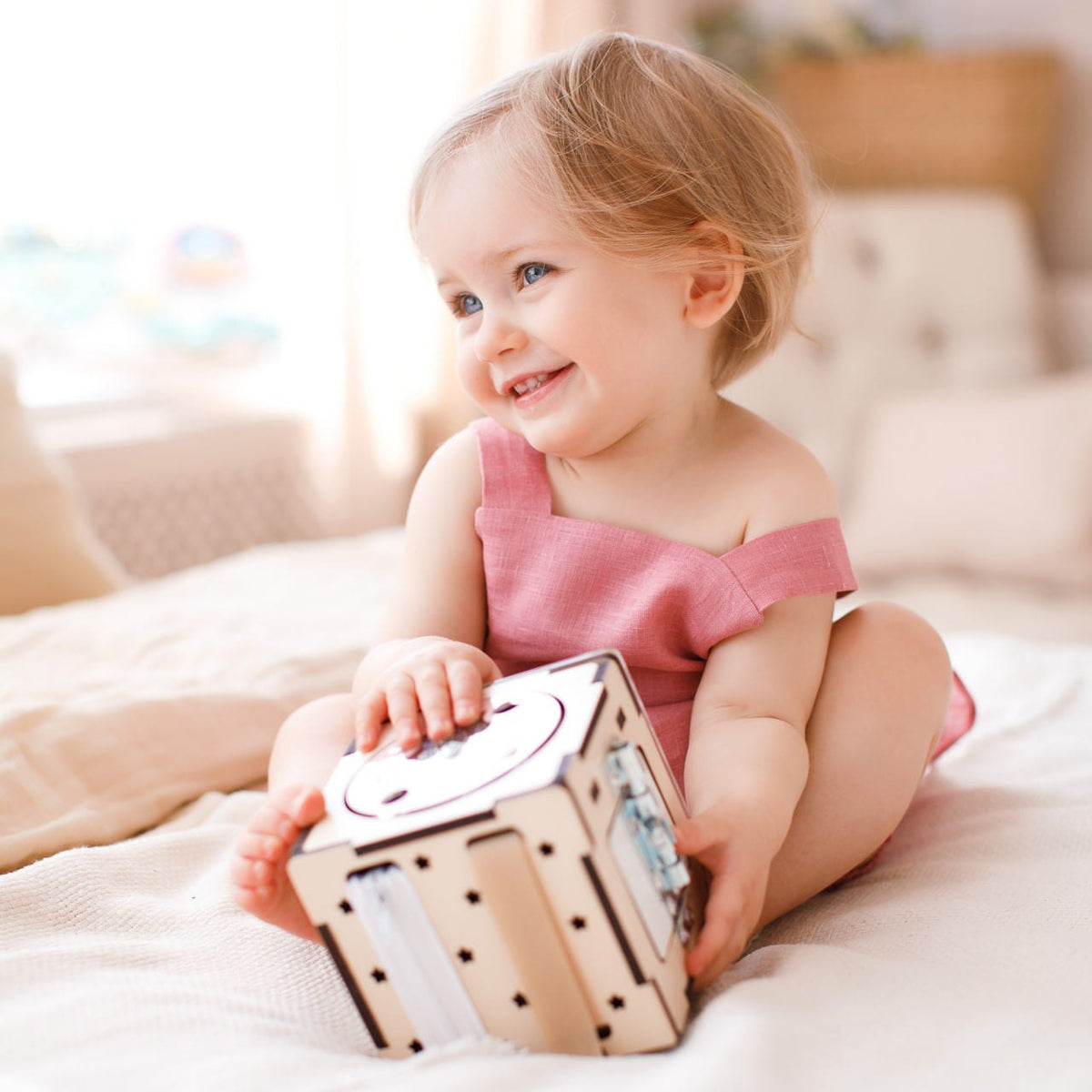 Interactive wooden cube toy for toddlers, enhancing motor skills and cognitive development.