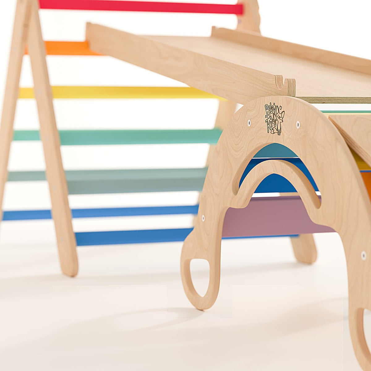 Children&#39;s indoor playset featuring a rainbow-colored climbing triangle and slide with ladder.