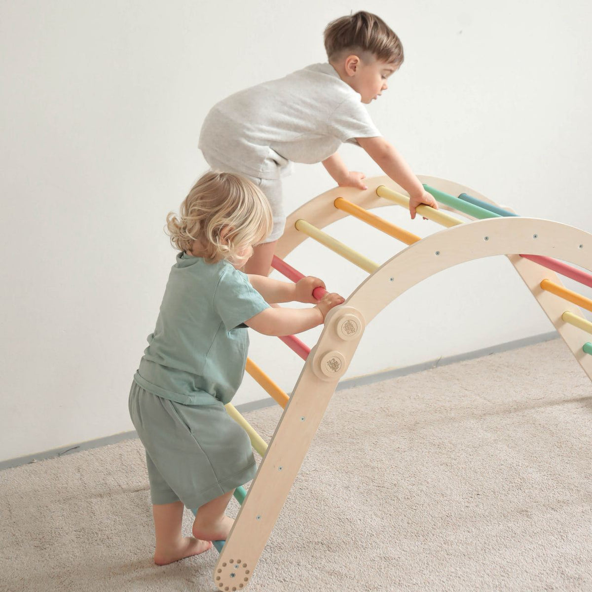 Children playing on a rainbow-colored climbing set