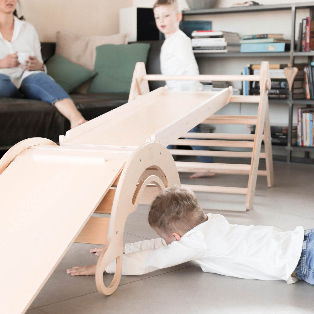 Sustainable wooden play set with Pikler triangle, slide, and balance rocker for kids.