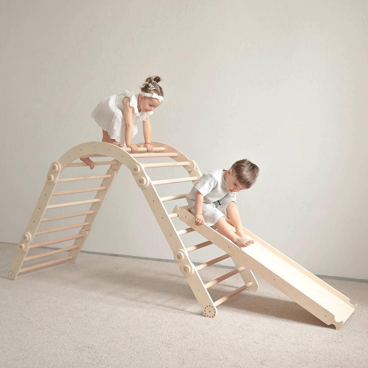 Children playing on a wooden climbing set with a slide, rainbow colors