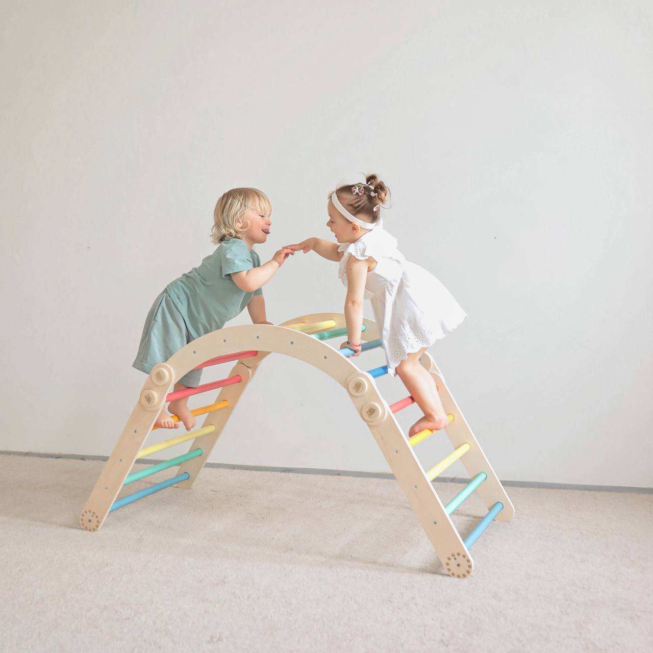 Colorful children's climbing frame with swing, featuring rainbow design and sturdy birch wood construction, perfect for motor skill development.