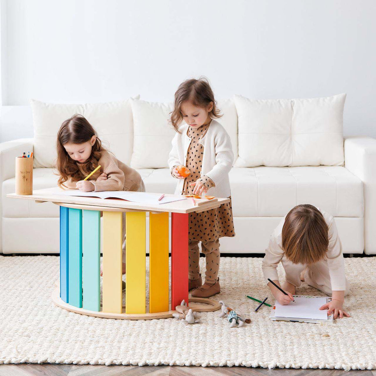 Children playing with Montessori balance rocker with colorful double-sided board in bright room.