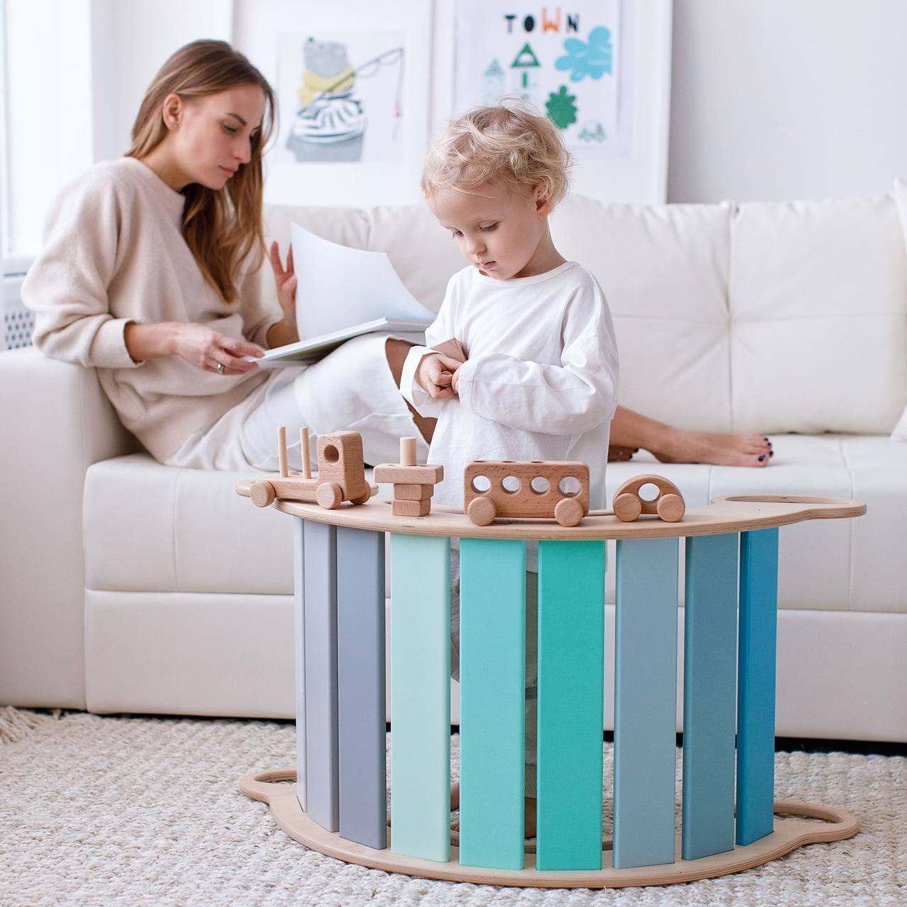 Mint-colored wooden balance board for children, versatile rocker and seat, Montessori-inspired design.