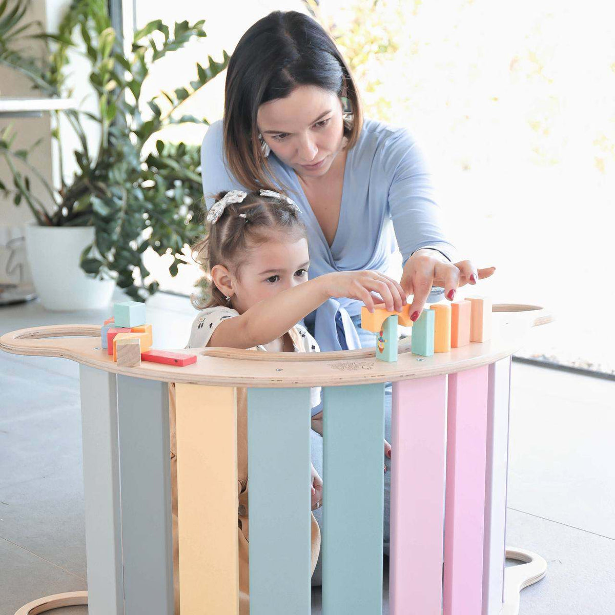 Pastel-colored balance rocker for kids and adults, eco-friendly multi-use design.